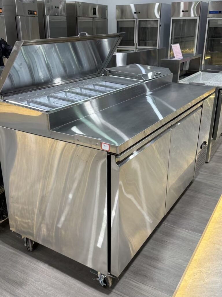 Heavy-duty commercial stainless steel pizza prep table refrigerator with refrigerated condiment pans and undercounter storage